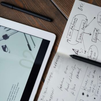 A tablet and notebook open comparing popular content marketing trends.