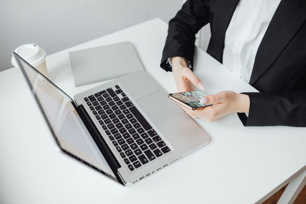 An accountant calculating prices of seo services on a phone at a desk