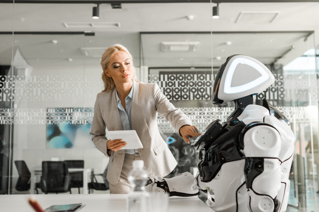 A business woman touching a robot as she thinks about seo for the finance industry.