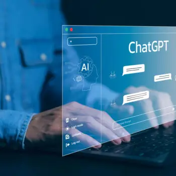 A man researching a ChatGPT SEO strategy with a pop up on his laptop showing ChatGPT.