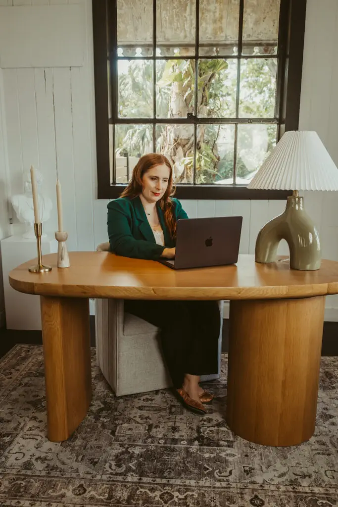 Beth Chernes at desk typing and researching SEO.