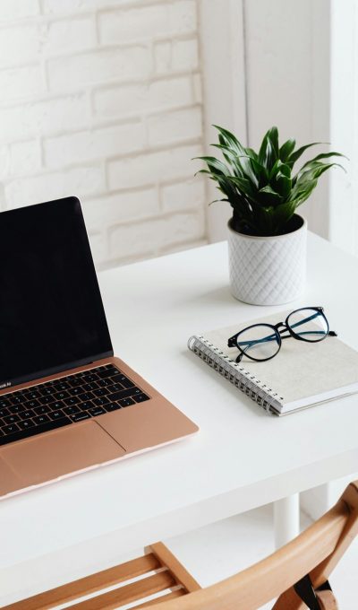 A minimalist desk is set up with a laptop, representing a clean workspace for SEO consulting and digital marketing work.